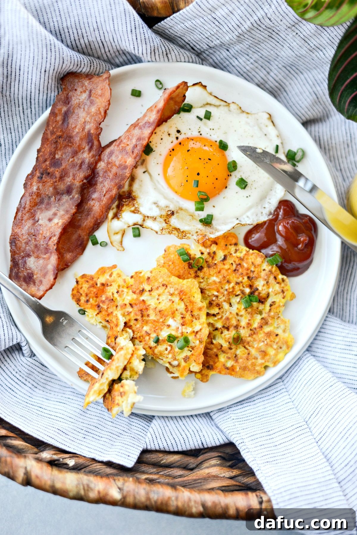 Golden Crispy Cauliflower Hash Browns 15 Cauliflower Breakfast Hash Browns stacked on a plate