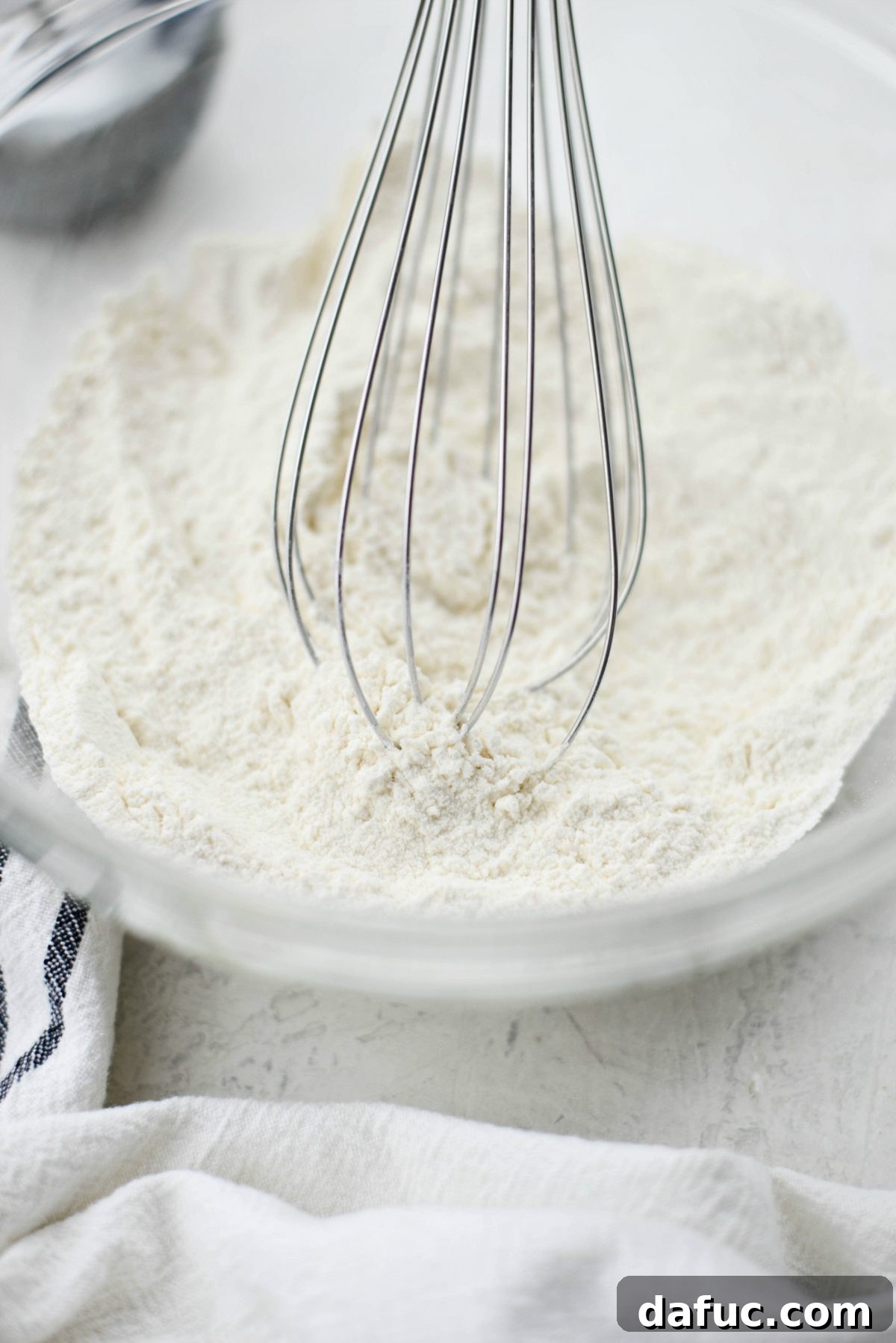 Whisking dry ingredients together in a bowl until fully combined