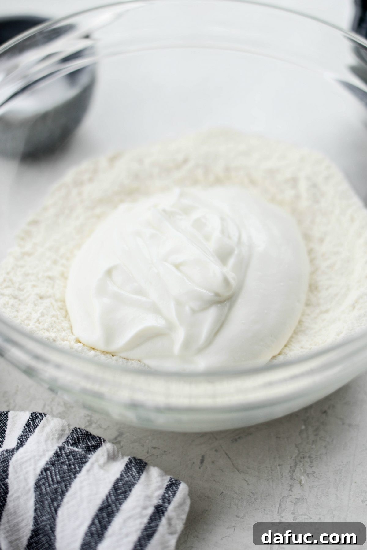 Adding plain non-fat Greek yogurt to the bowl of dry ingredients