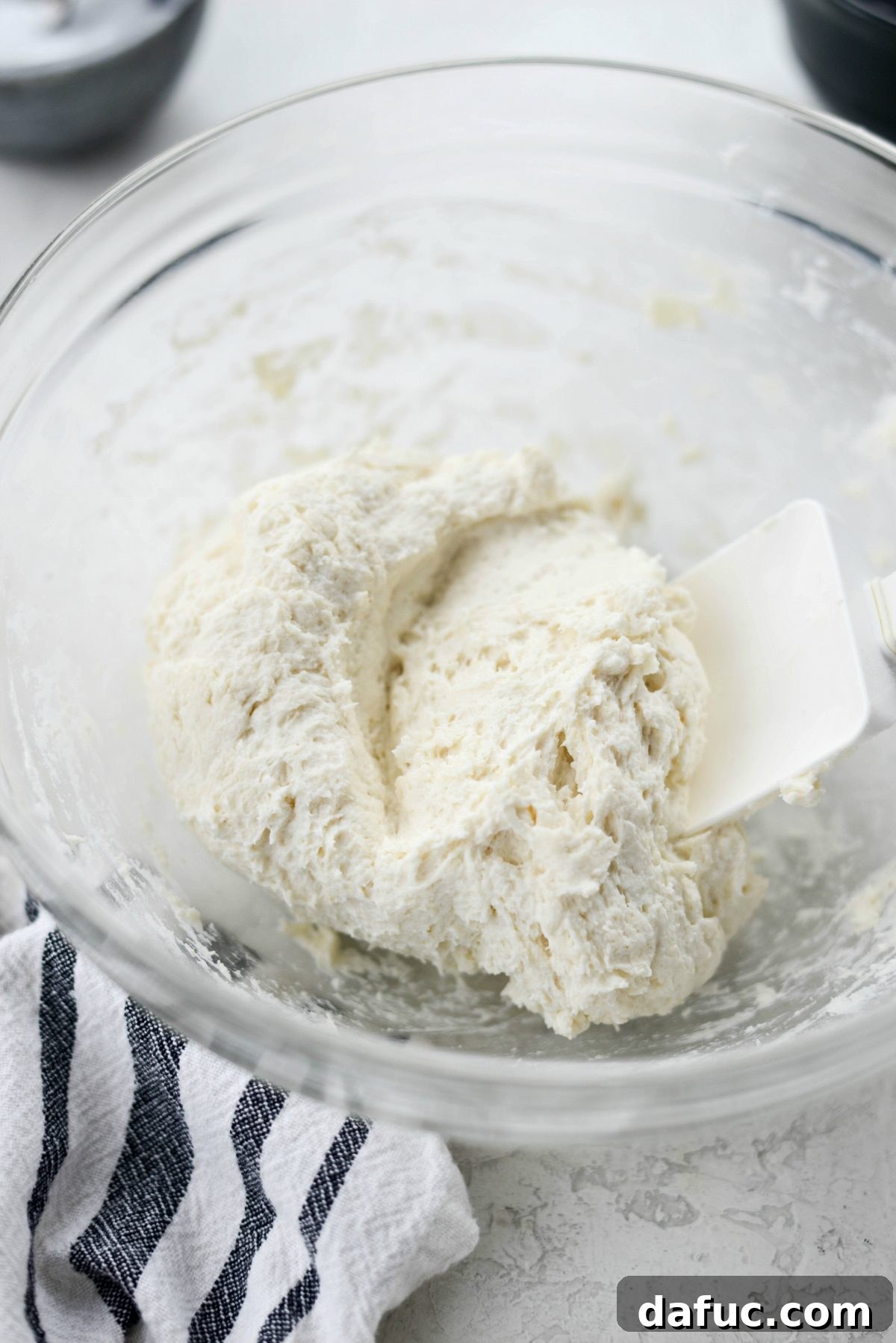 Close-up of the fully combined Greek yogurt pizza dough in a bowl