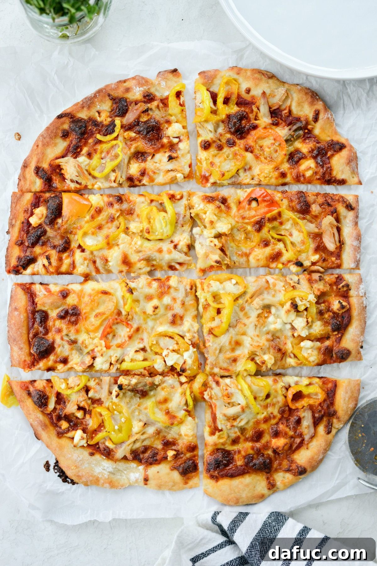 Freshly baked Spicy Chicken Feta Pizza with a golden crust and melted, bubbling cheese, straight from the oven