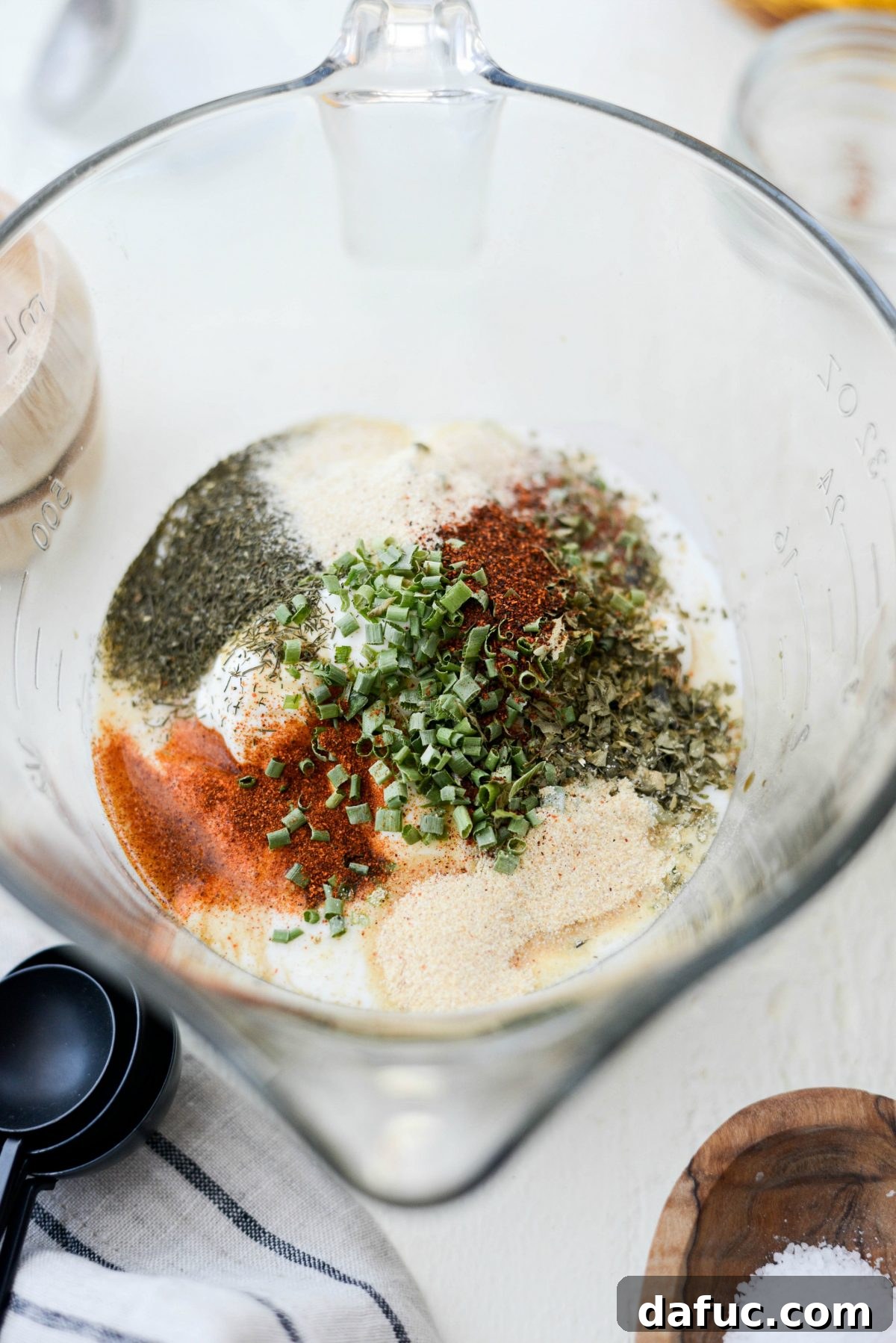 Measuring Greek Yogurt Ranch Dressing Ingredients into a Mixing Bowl