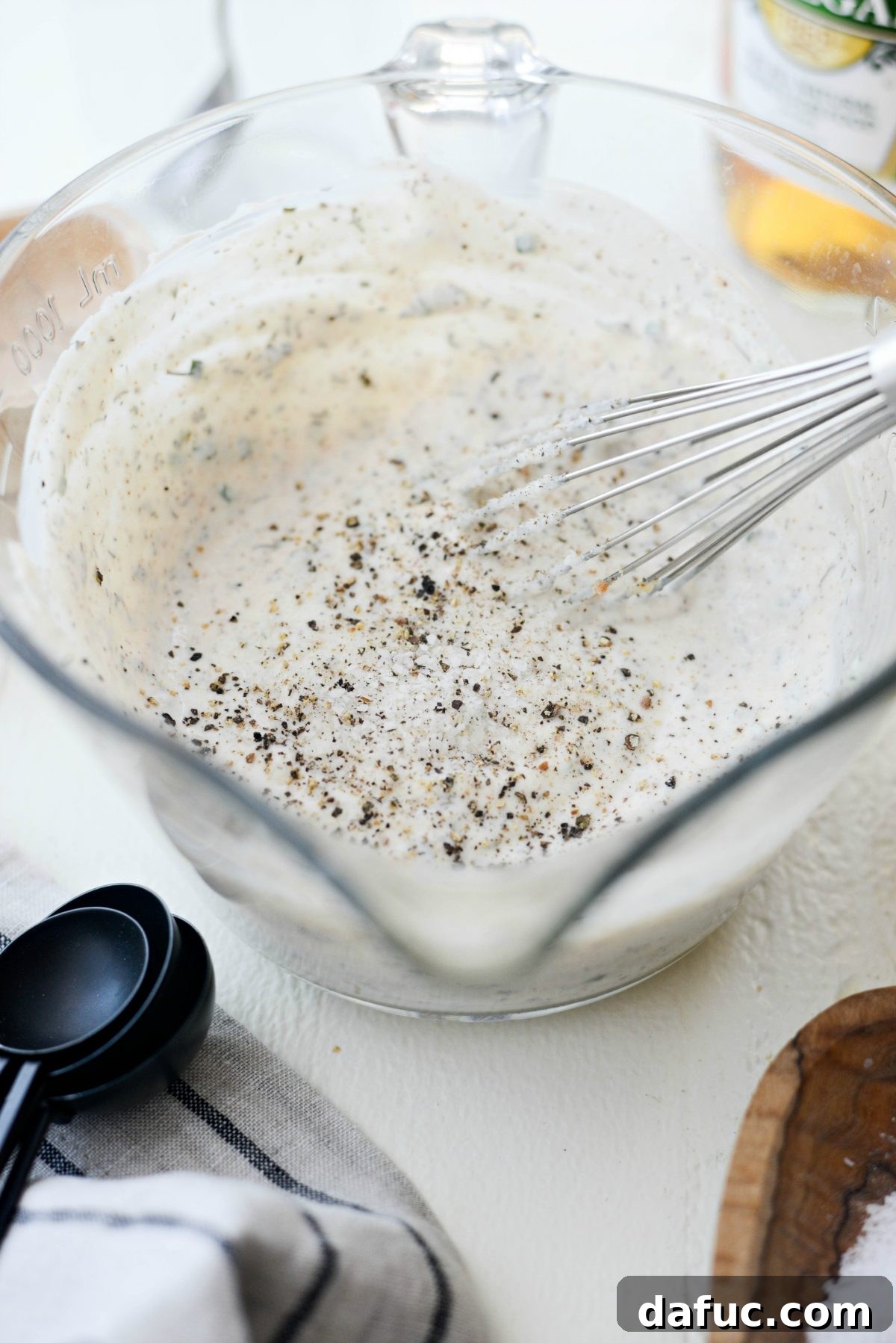 Seasoning the Greek Yogurt Ranch Dressing with Salt and Pepper