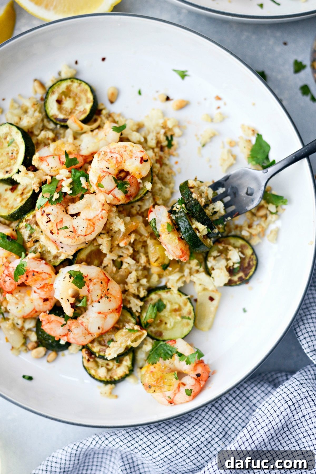 fork full of Sheet Pan Lemon Garlic Shrimp and Zucchini 