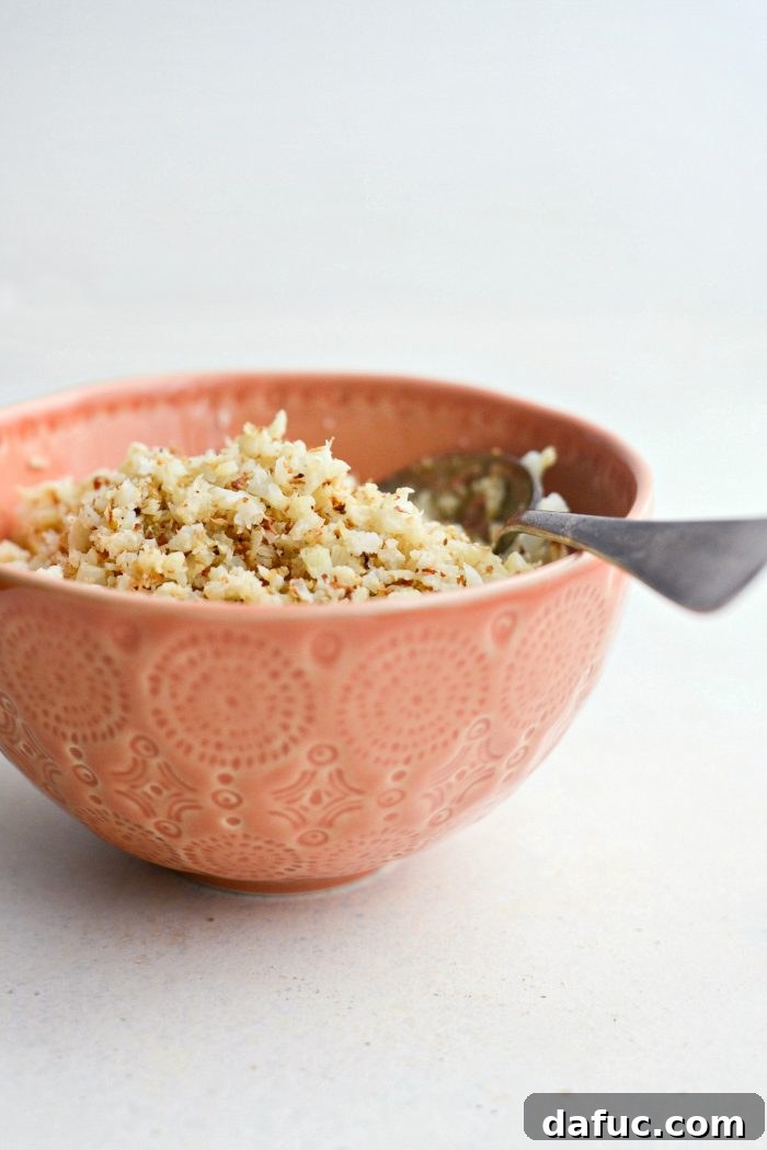 Crisp Roasted Cauliflower Grains 2 Golden brown roasted cauliflower rice in a pan
