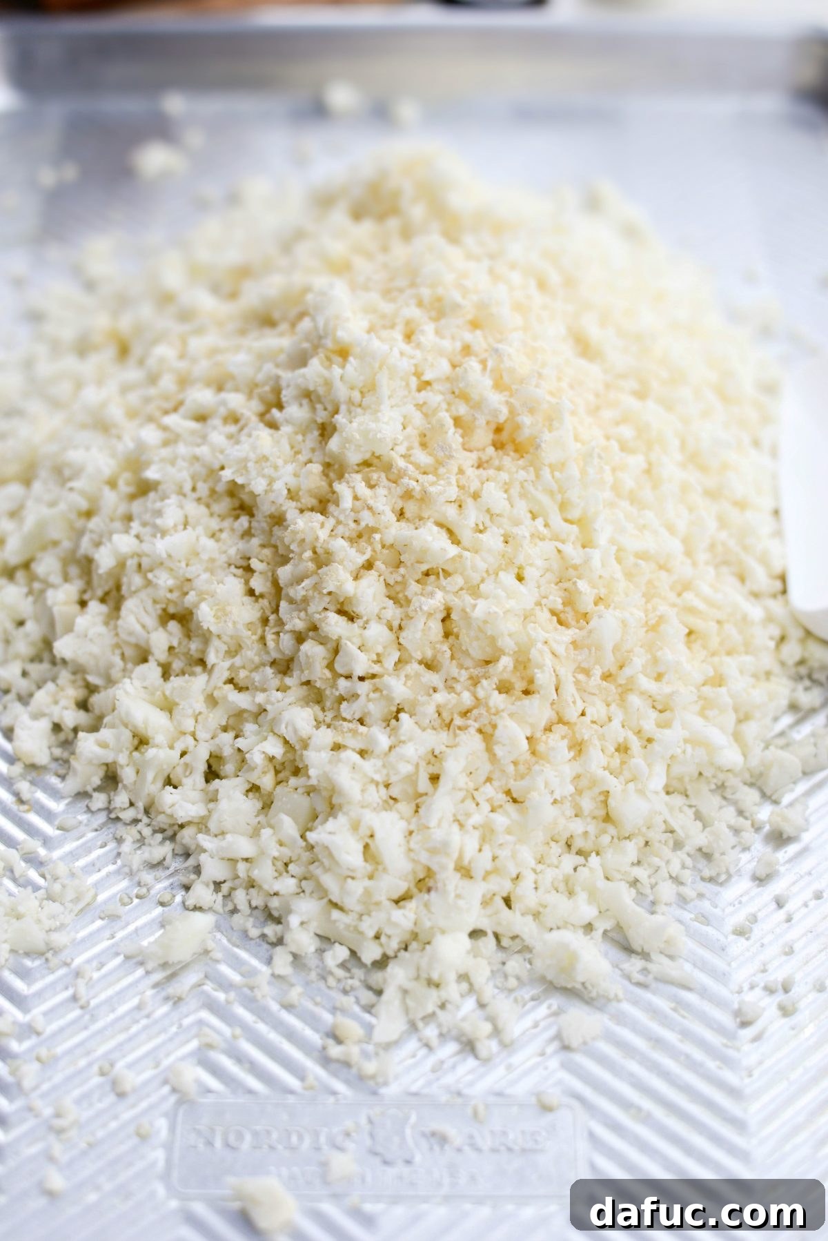 Crisp Roasted Cauliflower Grains 6 Riced cauliflower spread on a greased rimmed baking sheet