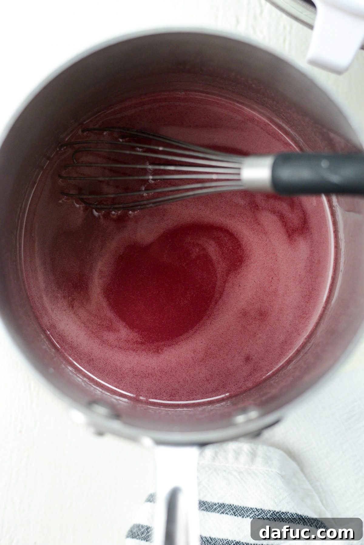 Whisking cherry pie filling until thickened