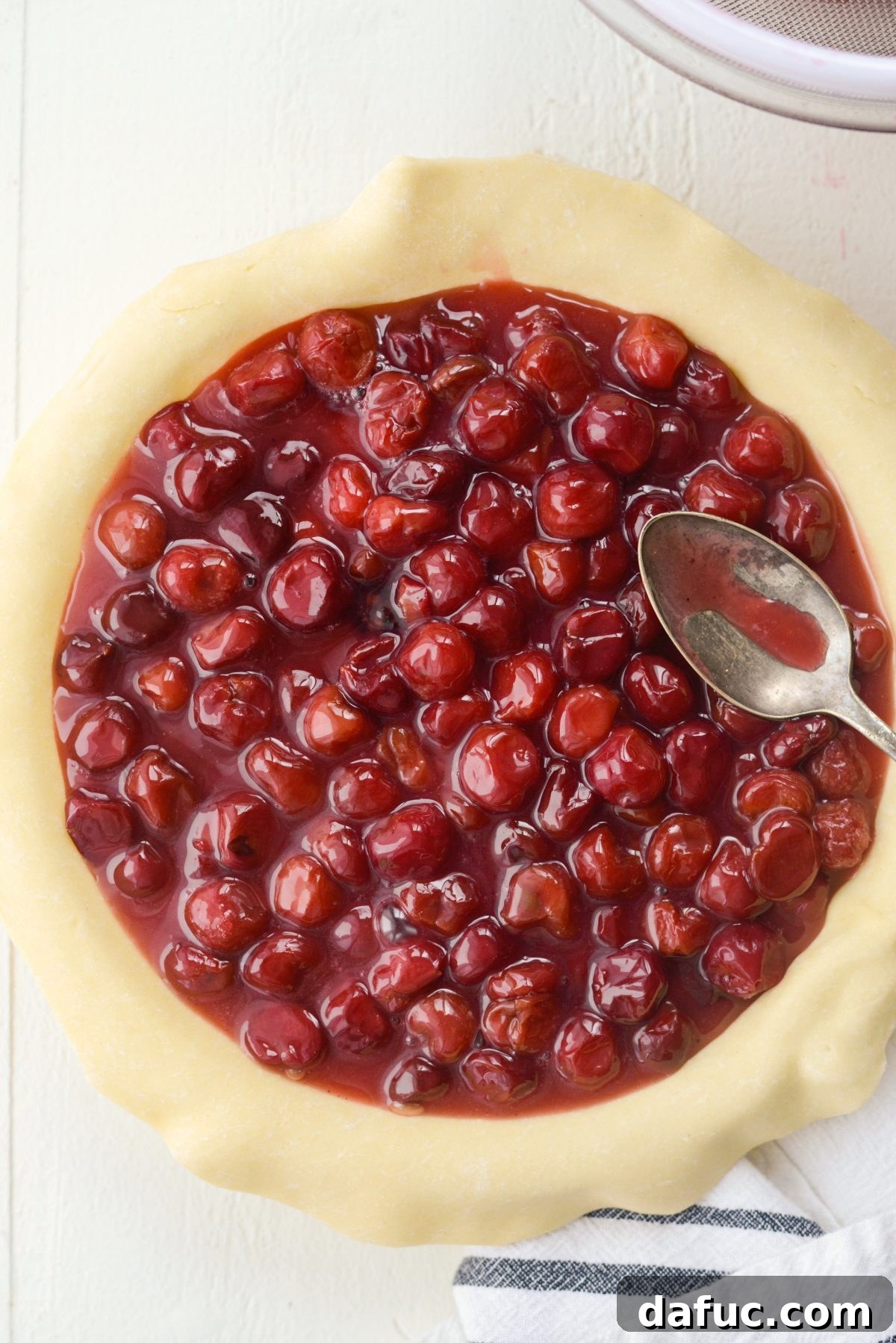 Spreading cherry pie filling evenly