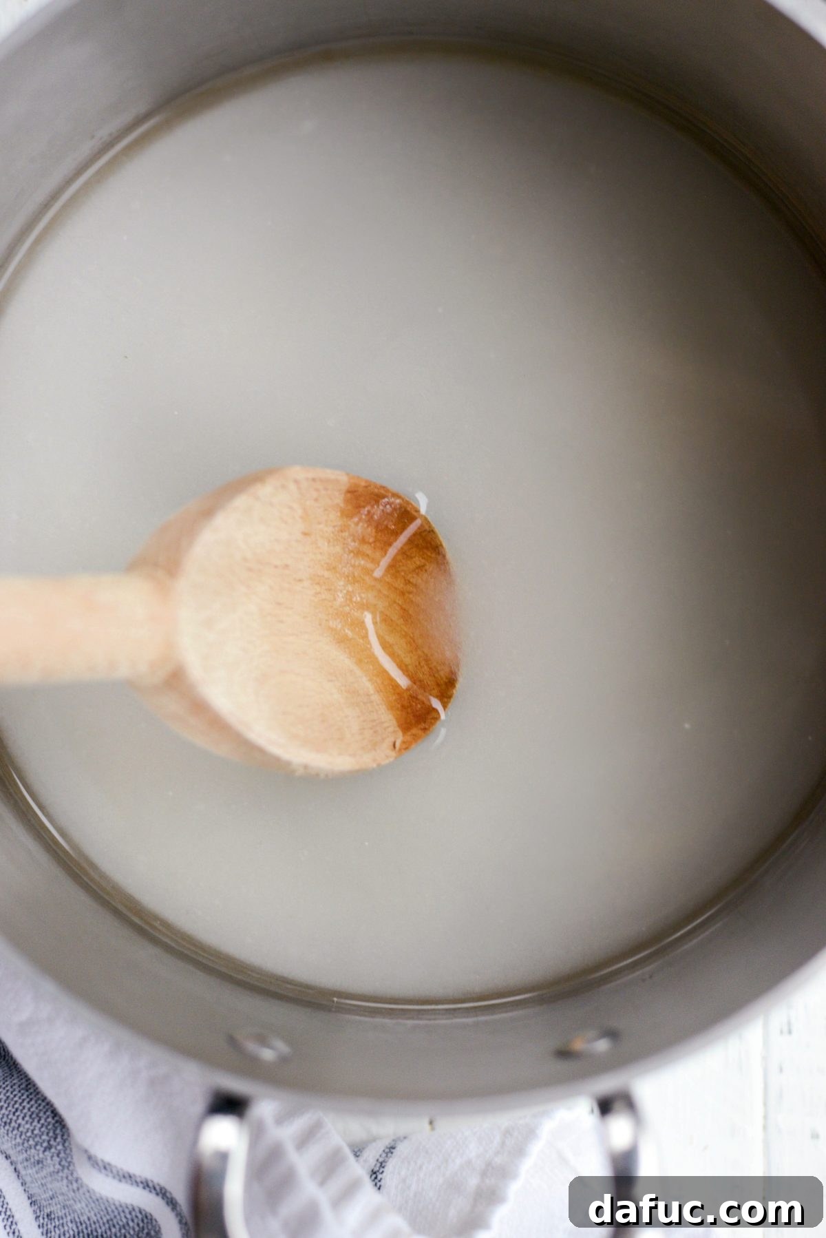 Naturally Crafted Maraschino Cherries 7 Stirring sugar and water in a saucepan