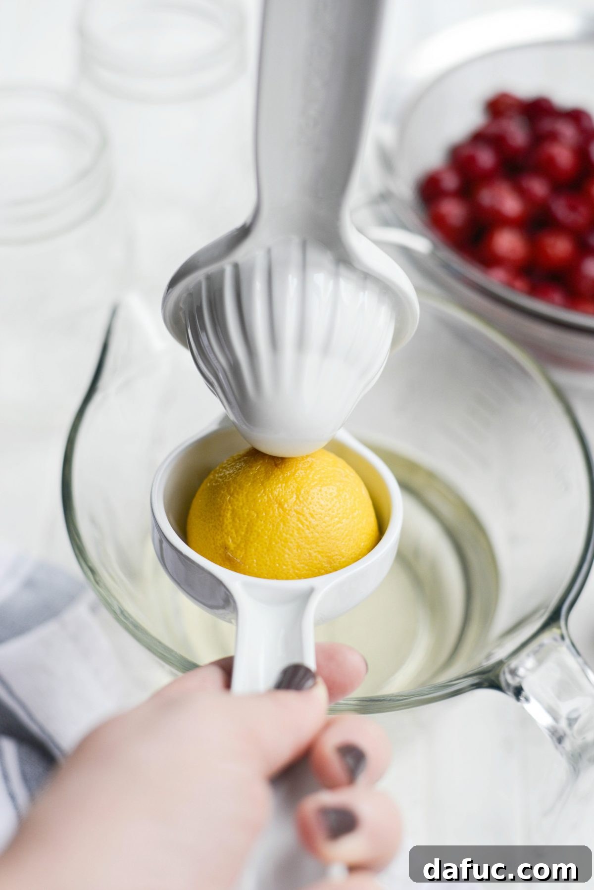 Naturally Crafted Maraschino Cherries 9 Squeezing lemon juice into the syrup
