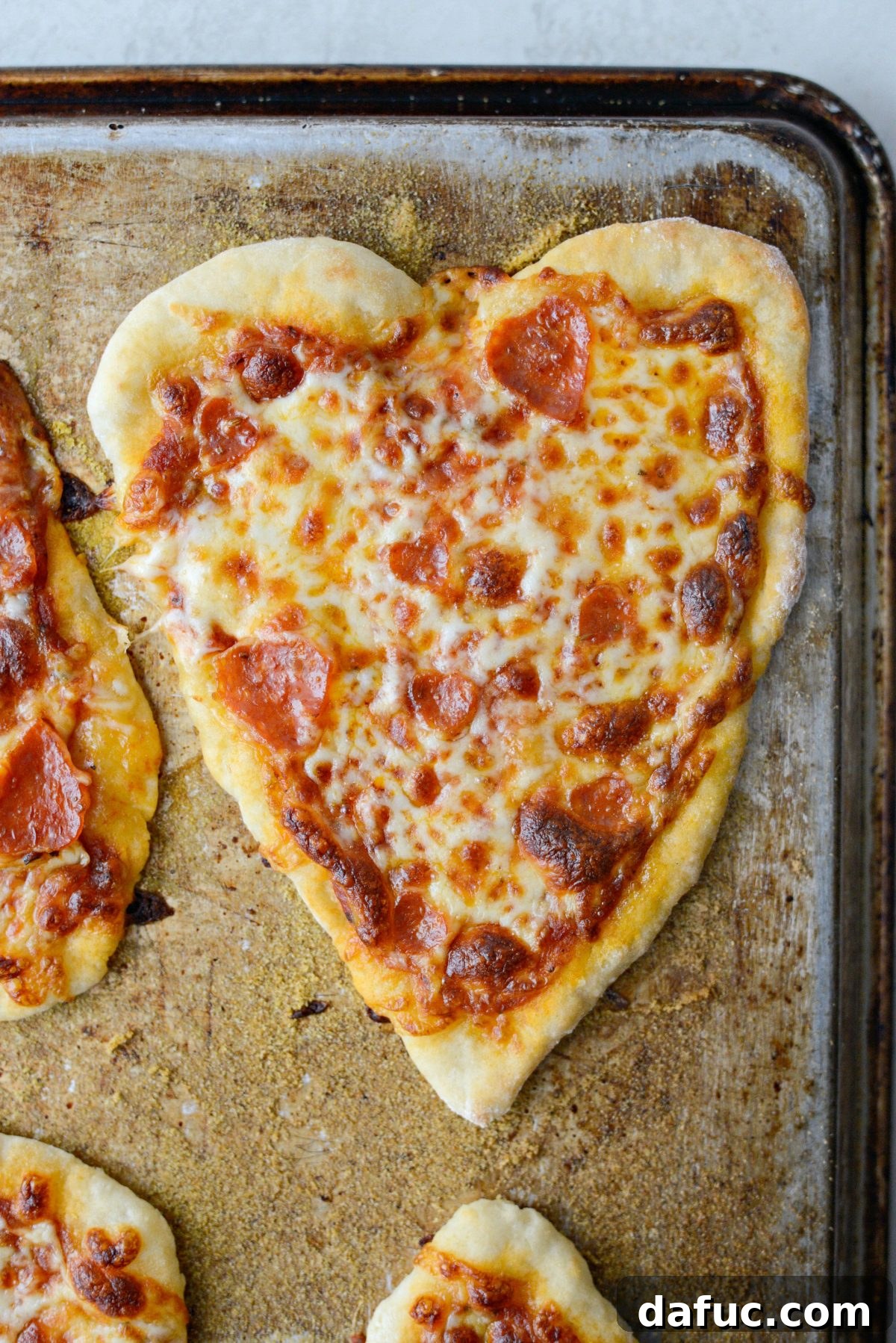 Sweetheart Pizza Treats 14 Heart shaped pizzas baking in the oven on the bottom rack