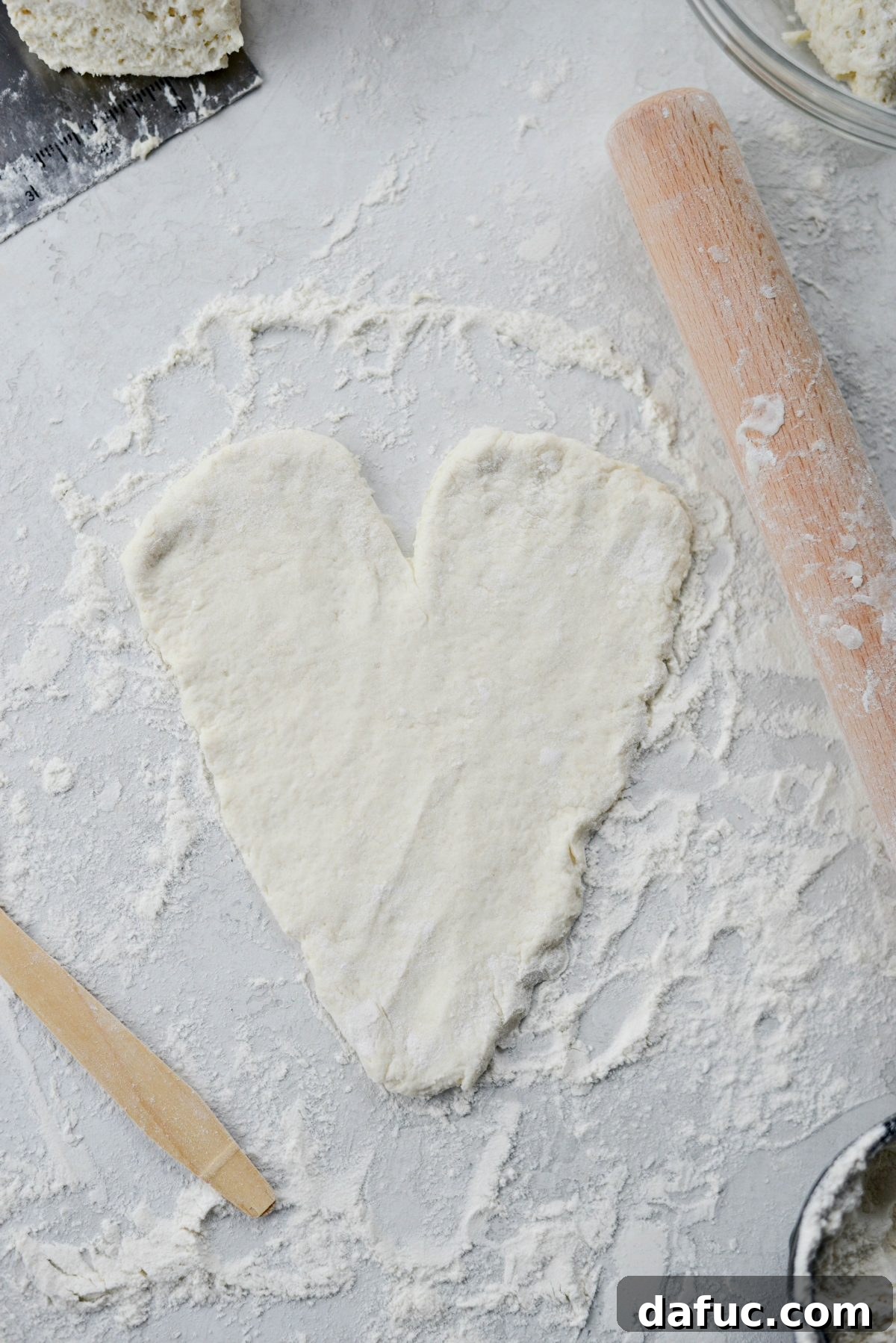 Sweetheart Pizza Treats 8 Process of rolling and shaping pizza dough into a heart, showing the notch and rounded edges