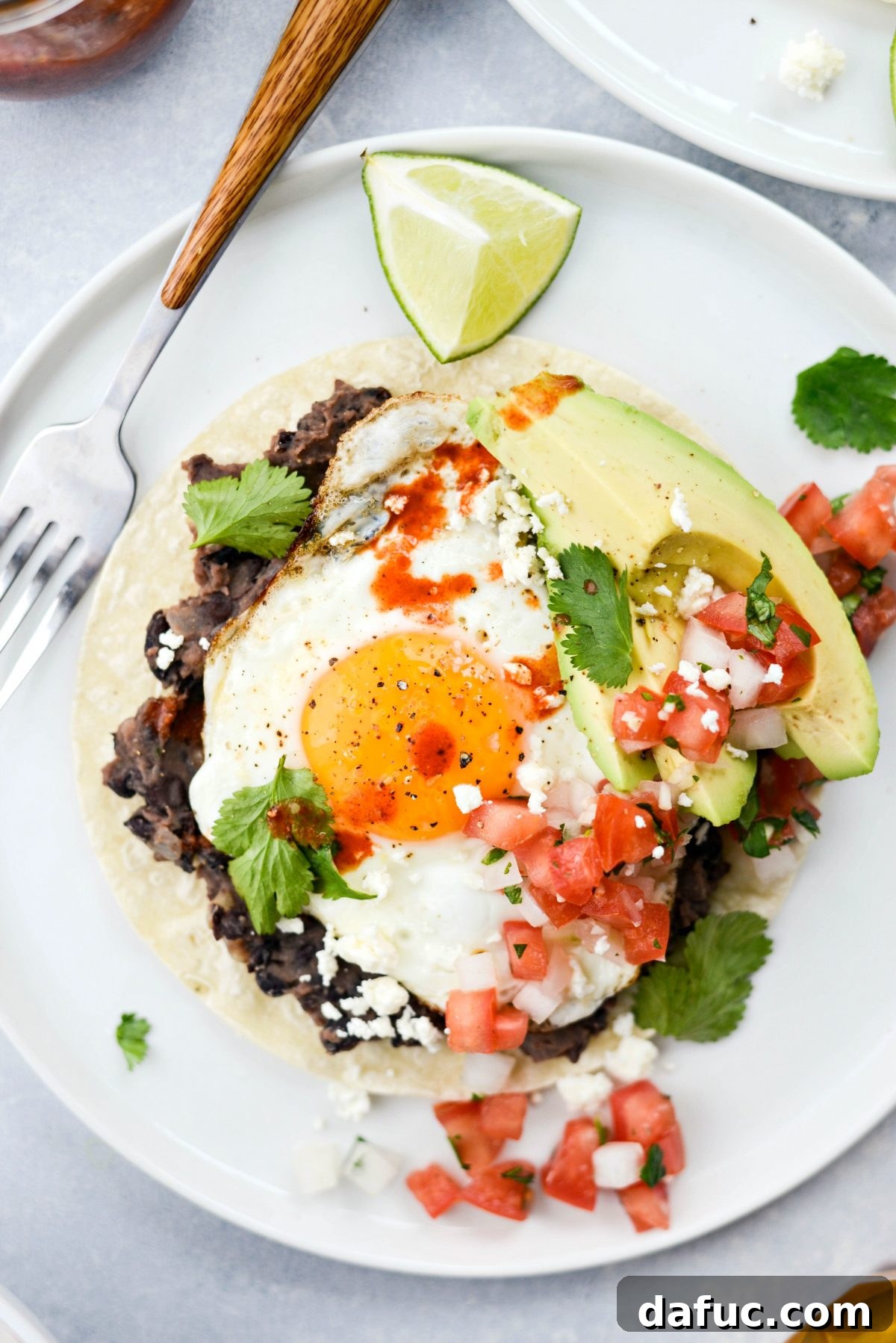 Delicious Huevos Rancheros served with fresh ingredients, showing eggs, beans, and fresh toppings