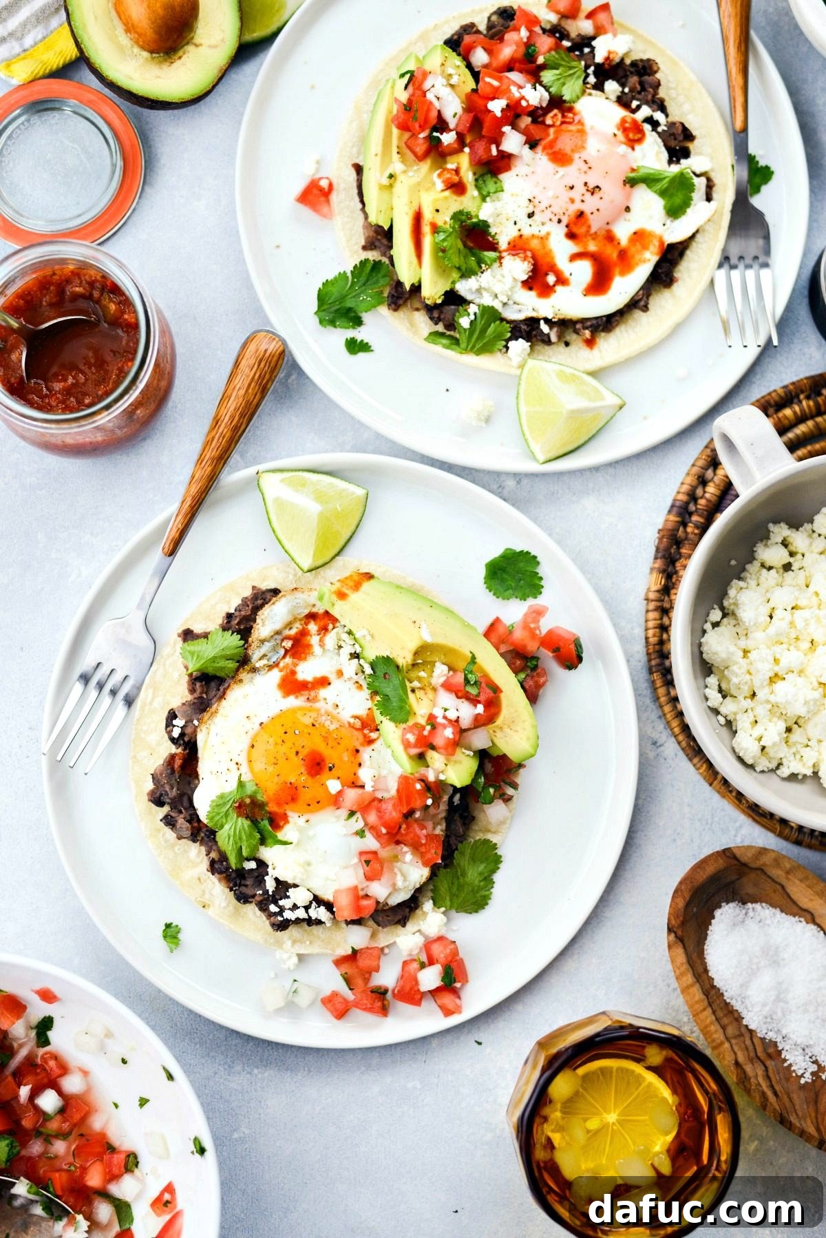 A close-up shot of a plate of Huevos Rancheros with fresh toppings