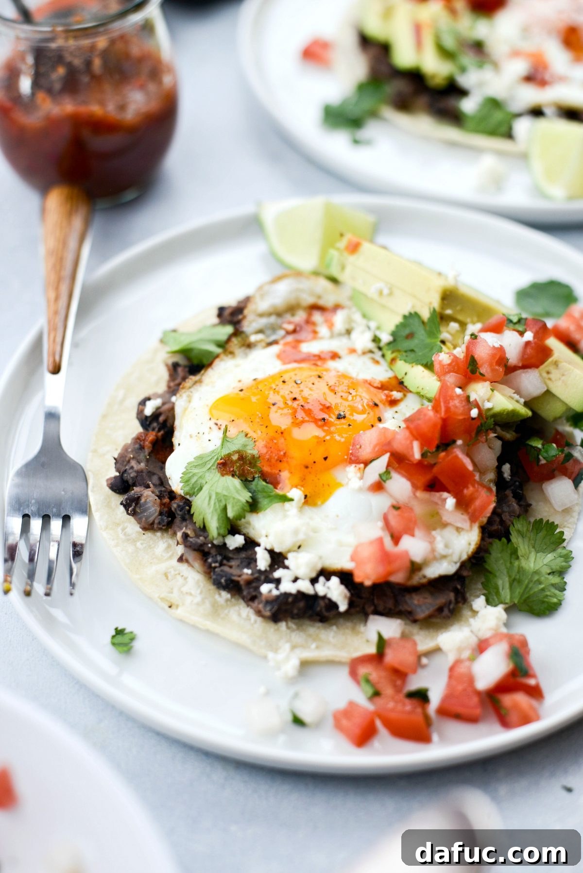 Overhead view of a prepared plate of Huevos Rancheros with a golden fried egg