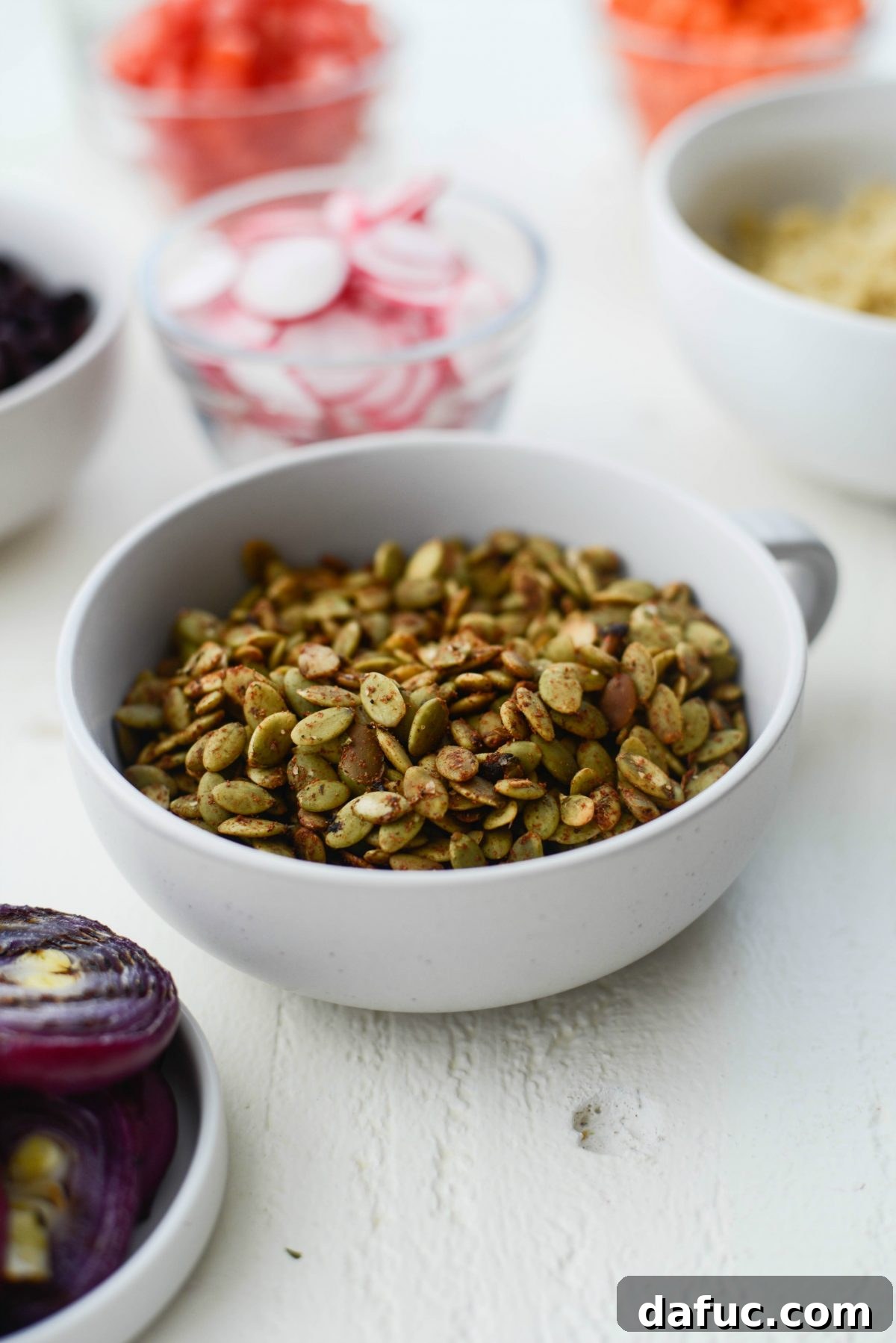 Executive Chop Salad 5 Close-up of seasoned toasted pepitas in a skillet