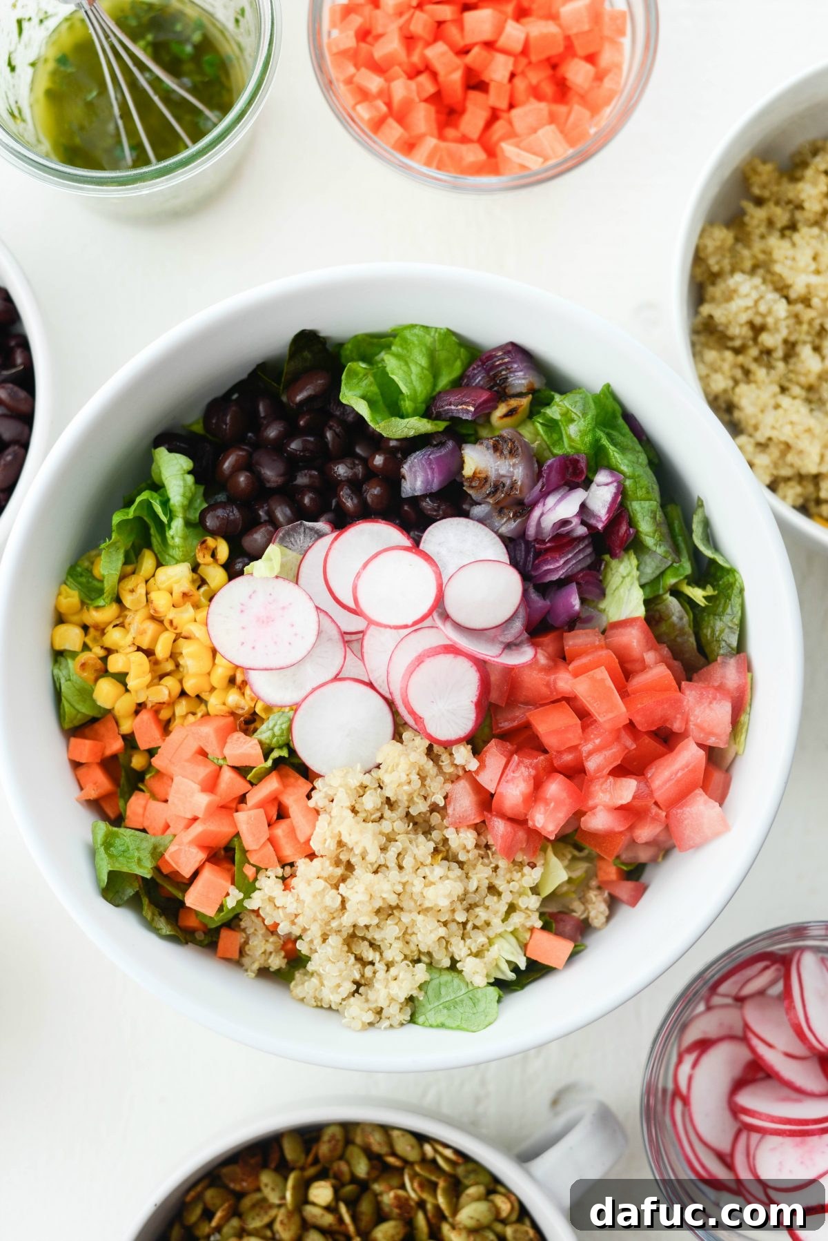 Executive Chop Salad 9 Adding various chopped vegetables to a bowl for the salad