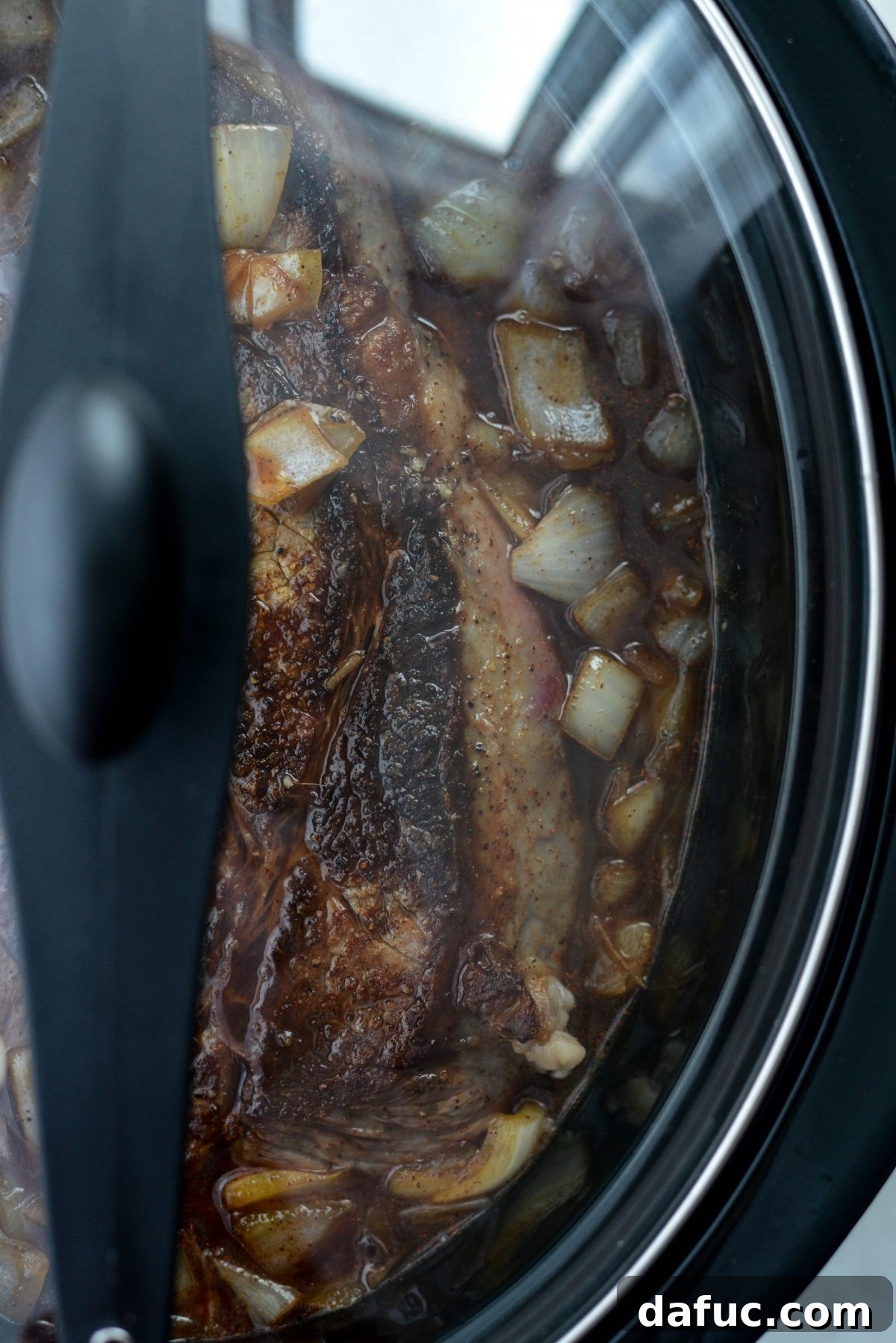 Fall-Apart Tender Slow Cooker Beef Barbacoa 13 The slow cooker covered, gently cooking the barbacoa on a low heat setting.