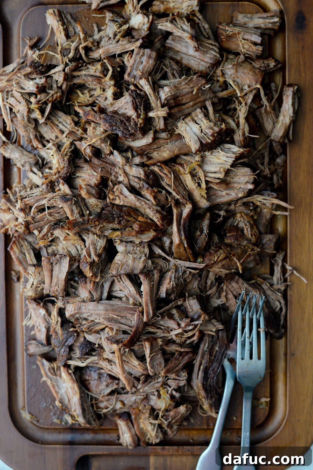 Fall-Apart Tender Slow Cooker Beef Barbacoa 16 A vibrant display of freshly shredded Beef Barbacoa, glistening with its flavorful sauce.