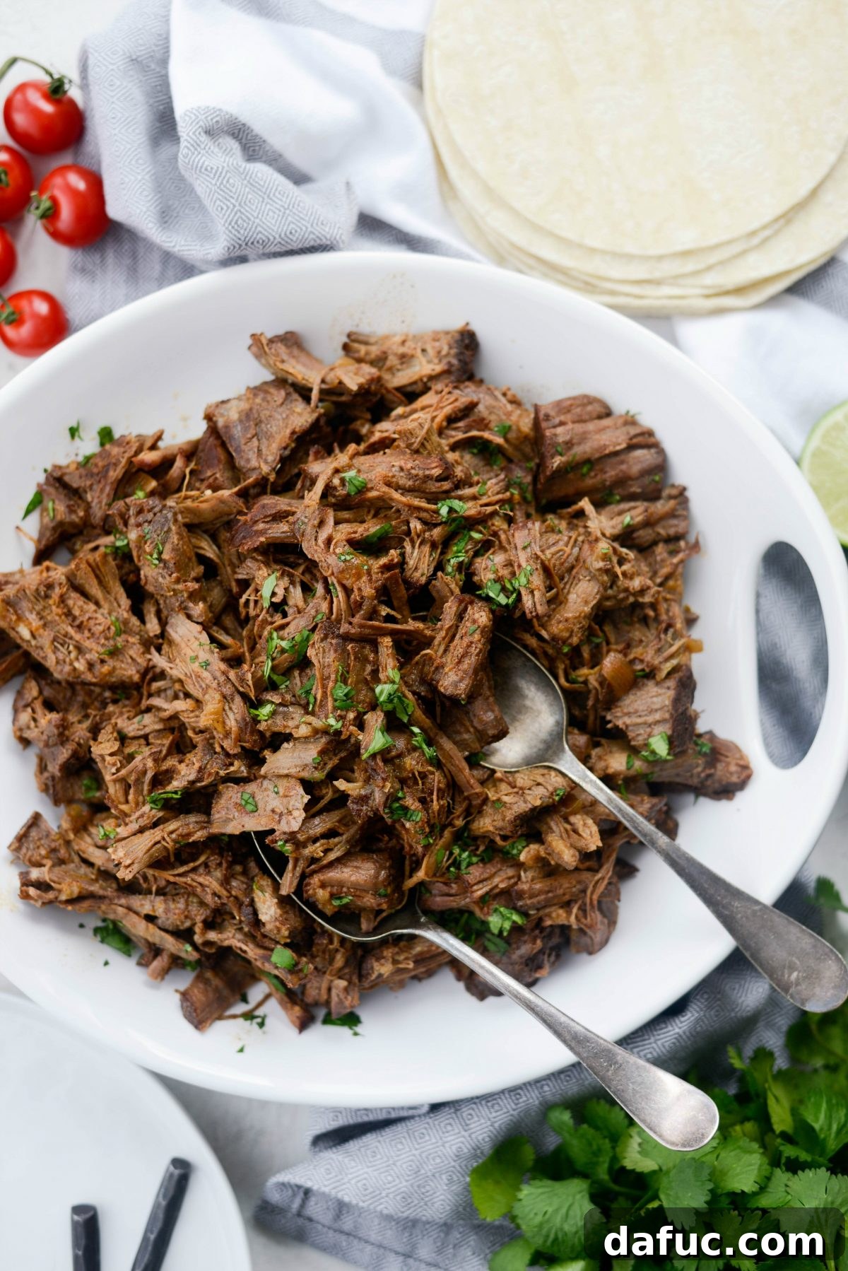 Fall-Apart Tender Slow Cooker Beef Barbacoa 18 A beautiful presentation of Slow Cooker Beef Barbacoa, highlighting its dark, rich color and appealing texture.