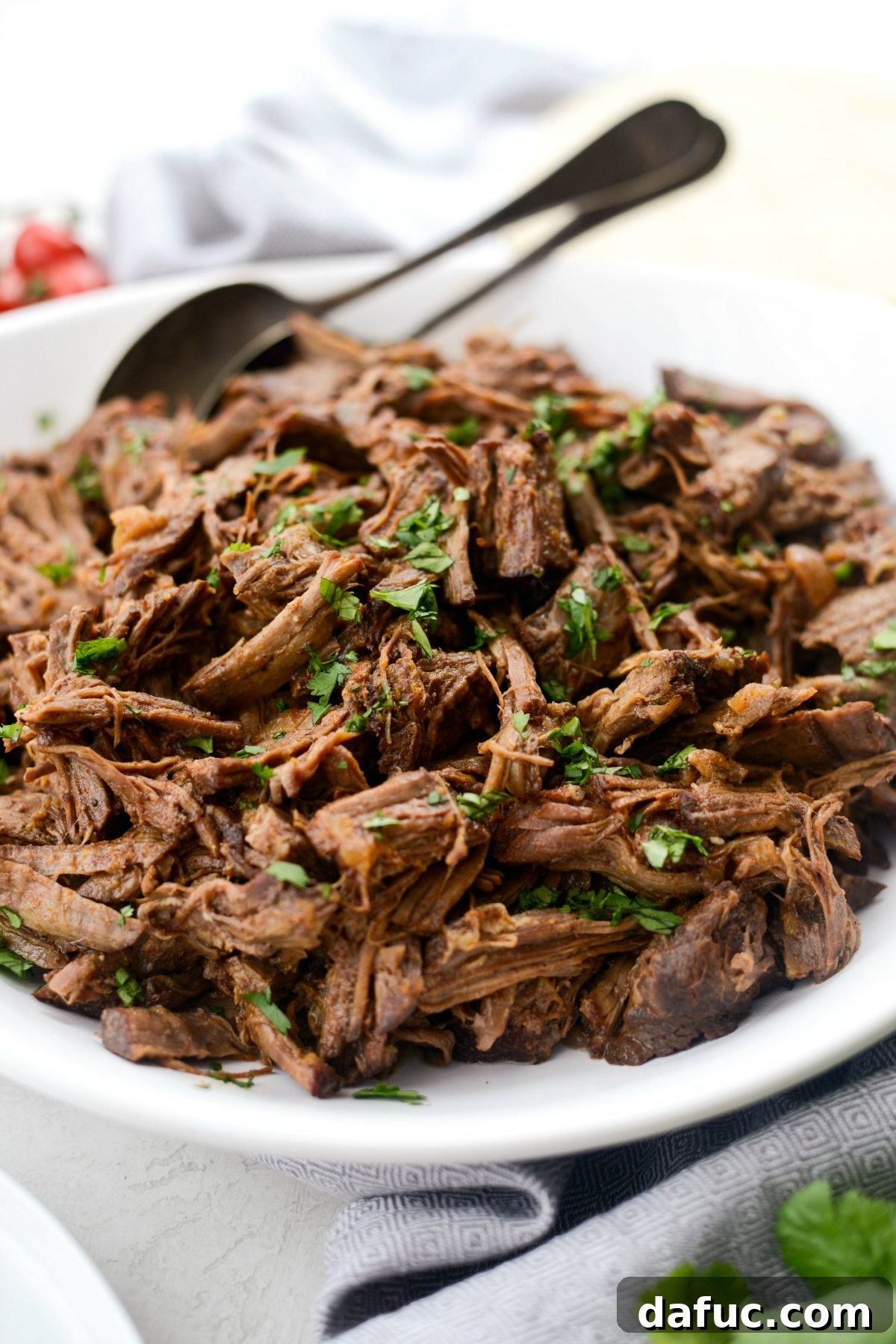 Fall-Apart Tender Slow Cooker Beef Barbacoa 3 A mouthwatering close-up of Slow Cooker Beef Barbacoa, highlighting its dark, rich color and perfectly shredded texture.