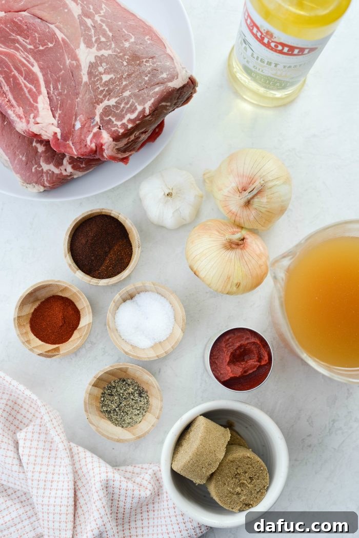 Fall-Apart Tender Slow Cooker Beef Barbacoa 4 A colorful array of fresh ingredients for Slow Cooker Beef Barbacoa, including chuck roast, onions, spices, and chicken stock.