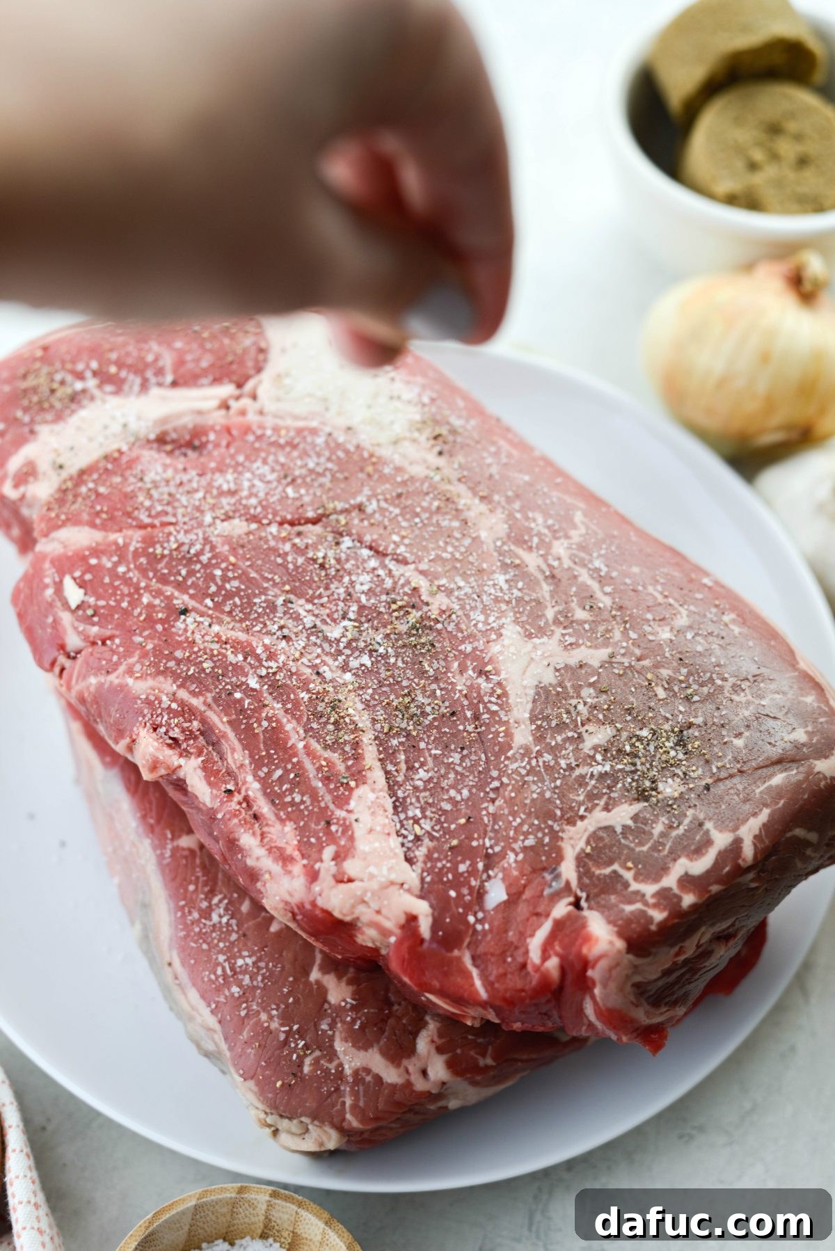 Fall-Apart Tender Slow Cooker Beef Barbacoa 5 Beef chuck roast generously seasoned on all sides with kosher salt and freshly ground black pepper.
