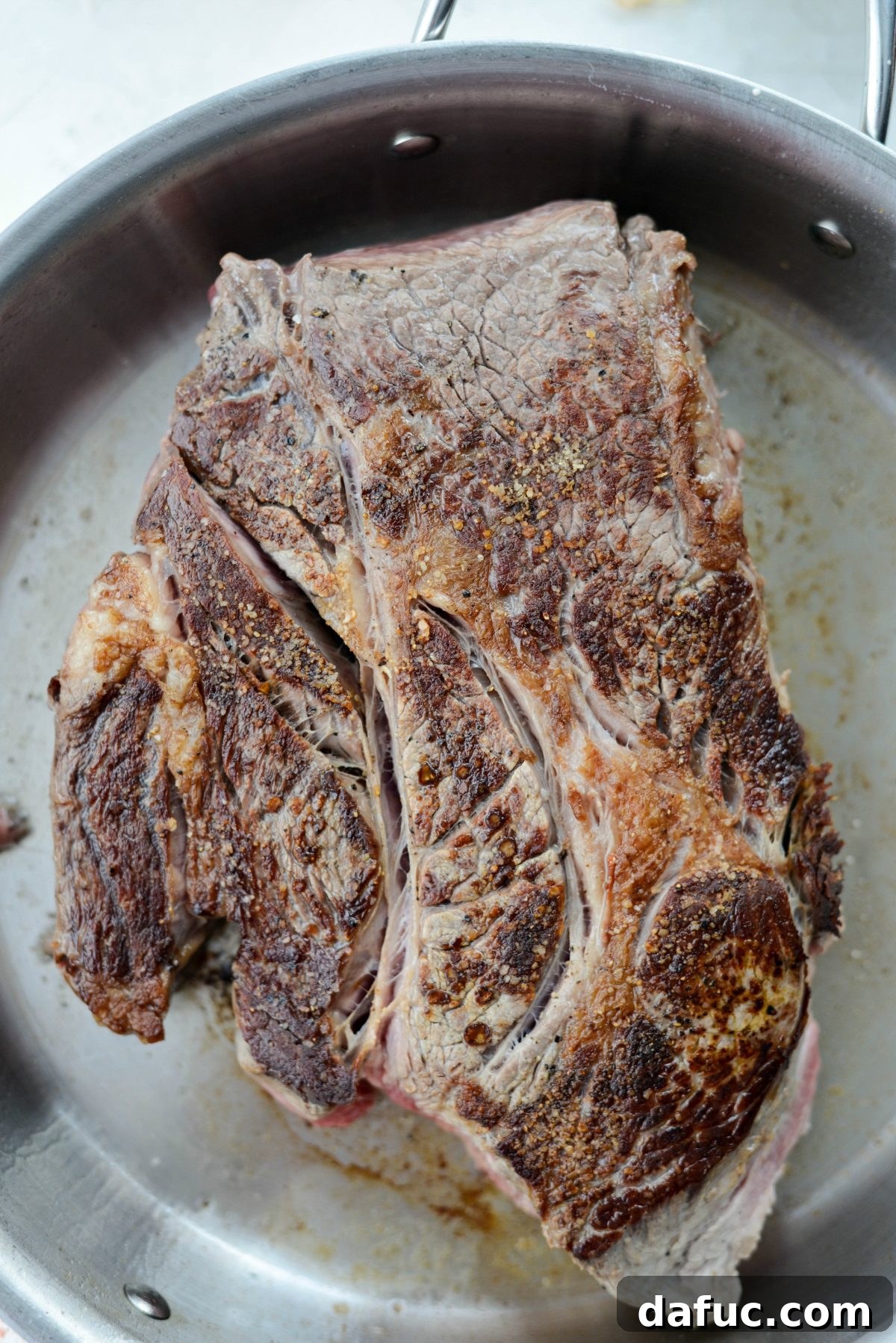 Fall-Apart Tender Slow Cooker Beef Barbacoa 6 Close-up of a perfectly seared beef chuck roast, showing its rich, golden-brown crust, ready for slow cooking.