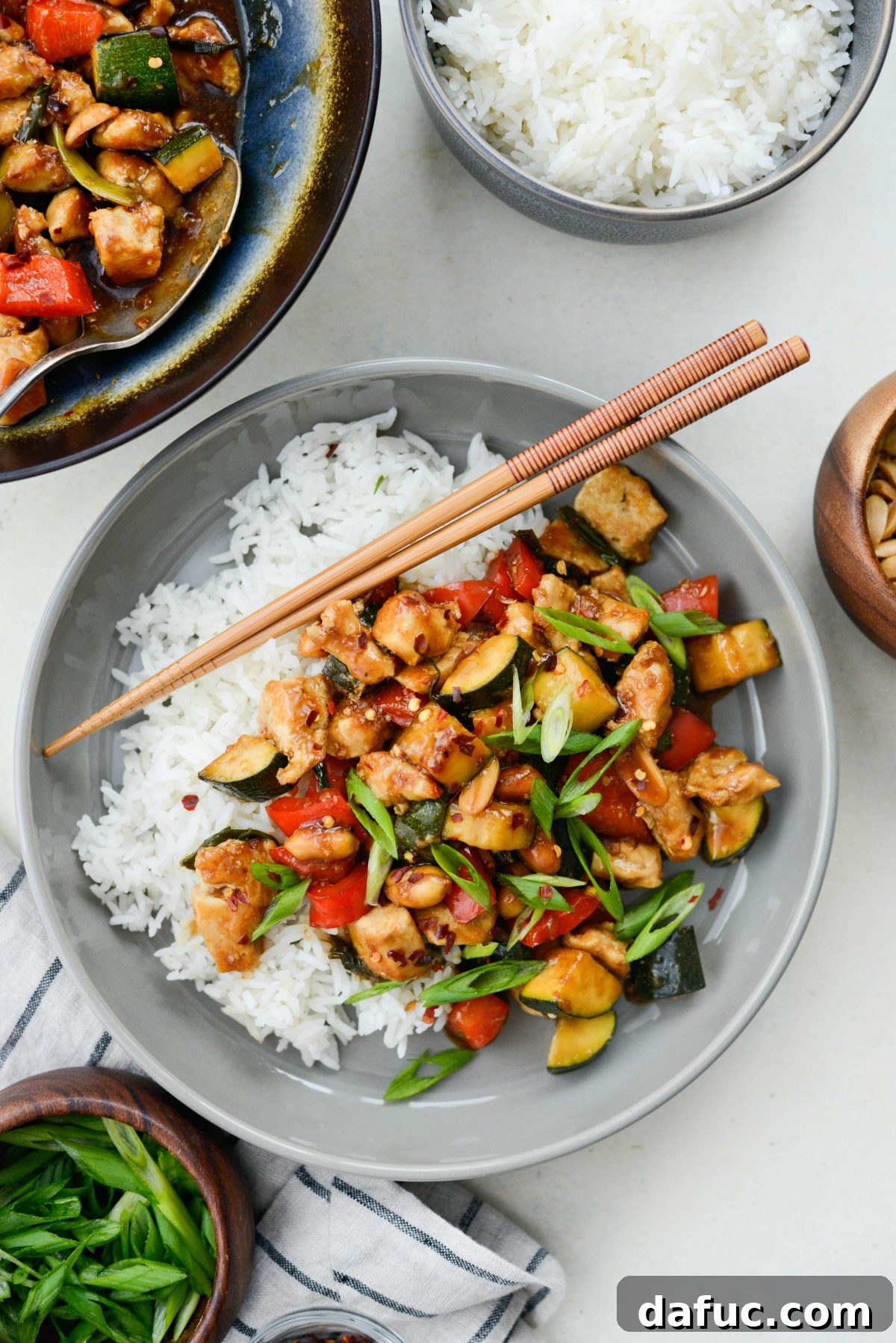 A final close-up of the delicious Kung Pao Chicken Stir-fry with a side of rice, showcasing the rich colors and textures of the completed dish.
