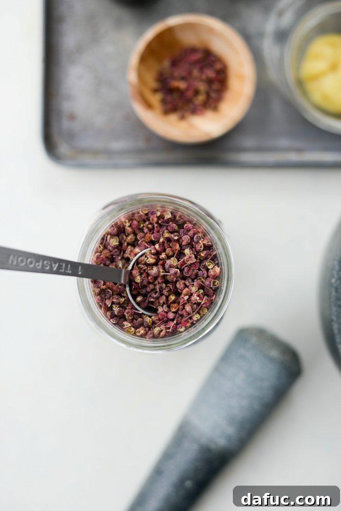 Szechuan Peppercorns in a spoon, ready for preparation