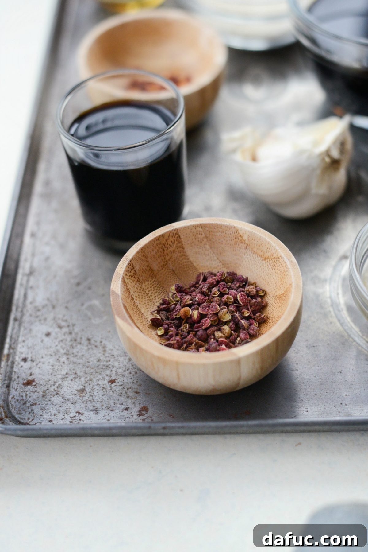 Close up of Szechuan Peppercorns in a small wooden bowl