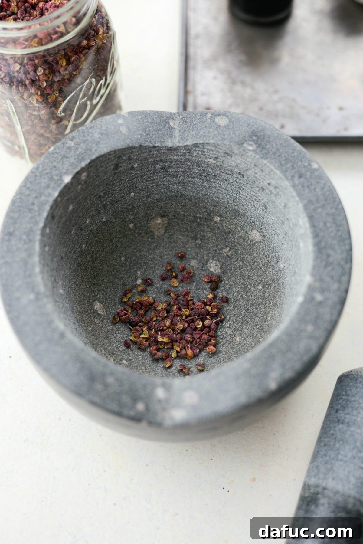 Szechuan Peppercorn Preparation Guide 5 Szechuan Peppercorns in a mortar and pestle