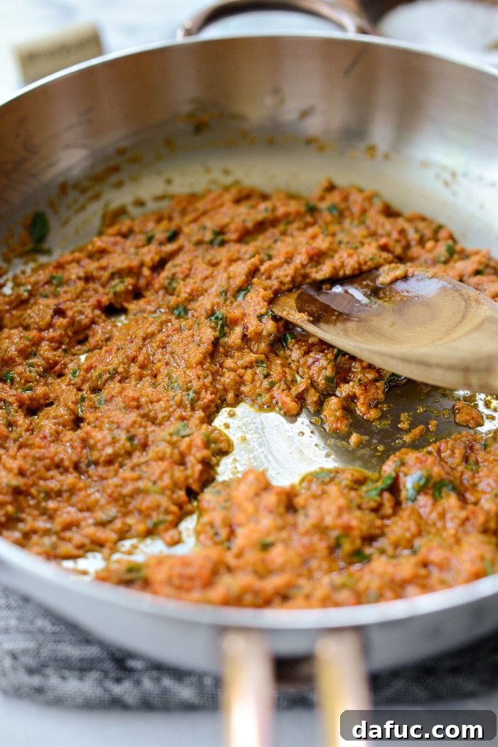Golden Walnut & Sun-dried Tomato Pesto Pasta 11 Sun-dried Tomato Walnut Pesto being sautéed in a skillet, starting to caramelize