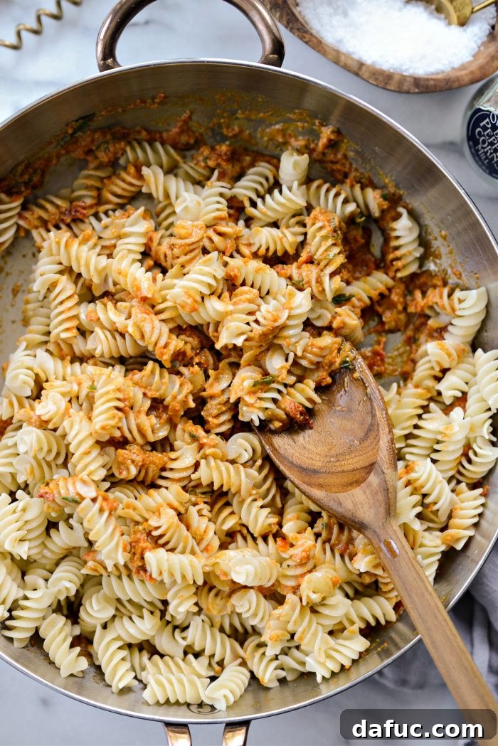 Golden Walnut & Sun-dried Tomato Pesto Pasta 14 Sun-dried Tomato Walnut Pesto Pasta being tossed in the skillet to coat evenly