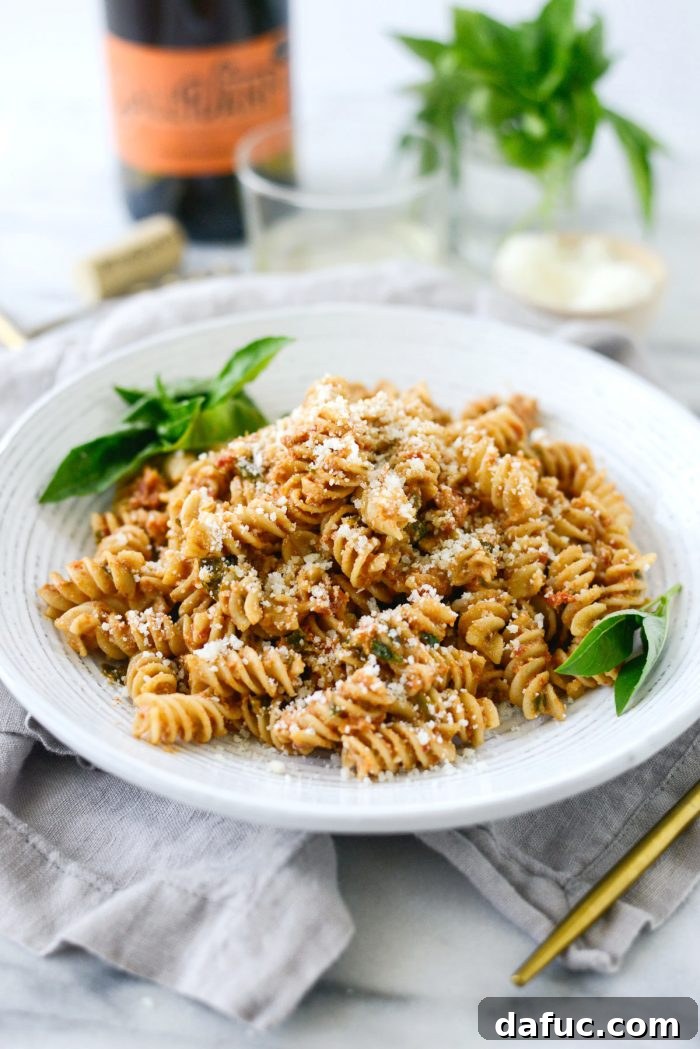 Golden Walnut & Sun-dried Tomato Pesto Pasta 3 Overhead shot of freshly made Sun-dried Tomato Toasted Walnut Pesto Pasta with fresh basil garnish