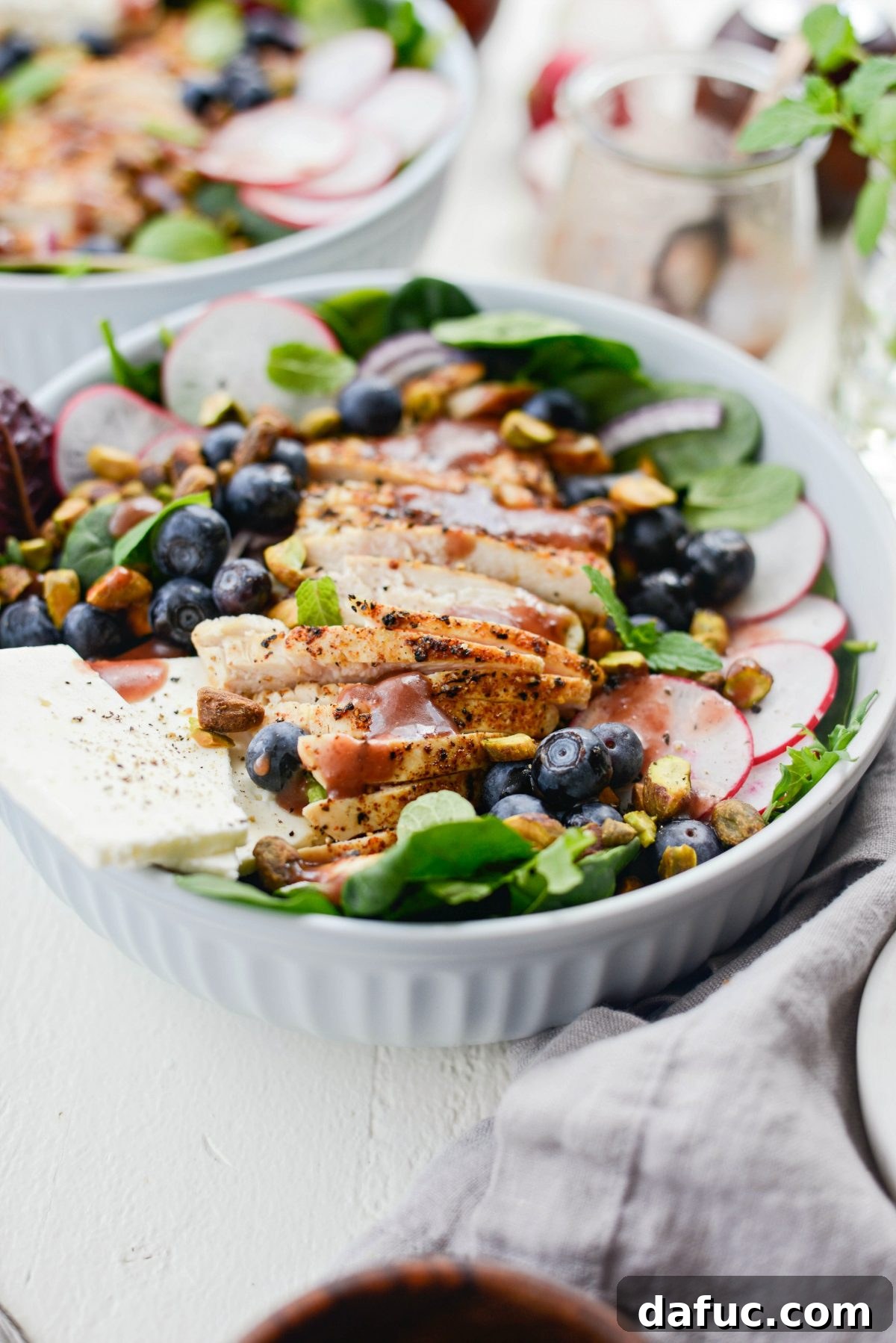 Two bowls of Chicken Blueberry Feta Salad with Pomegranate Jam Vinaigrette