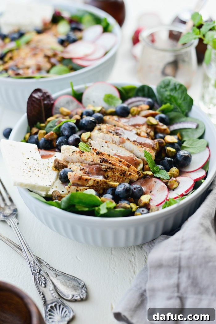 Overhead view of Chicken Blueberry Feta Salad with dressing ready to be served