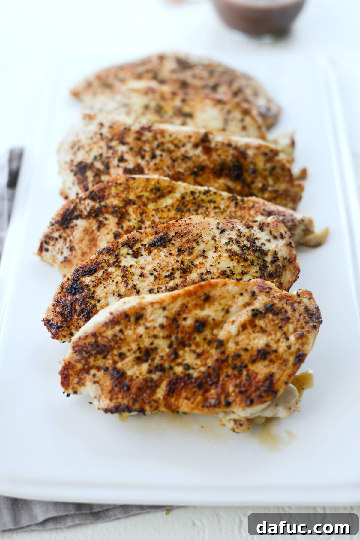 Cooked, sliced chicken breast ready for salad assembly
