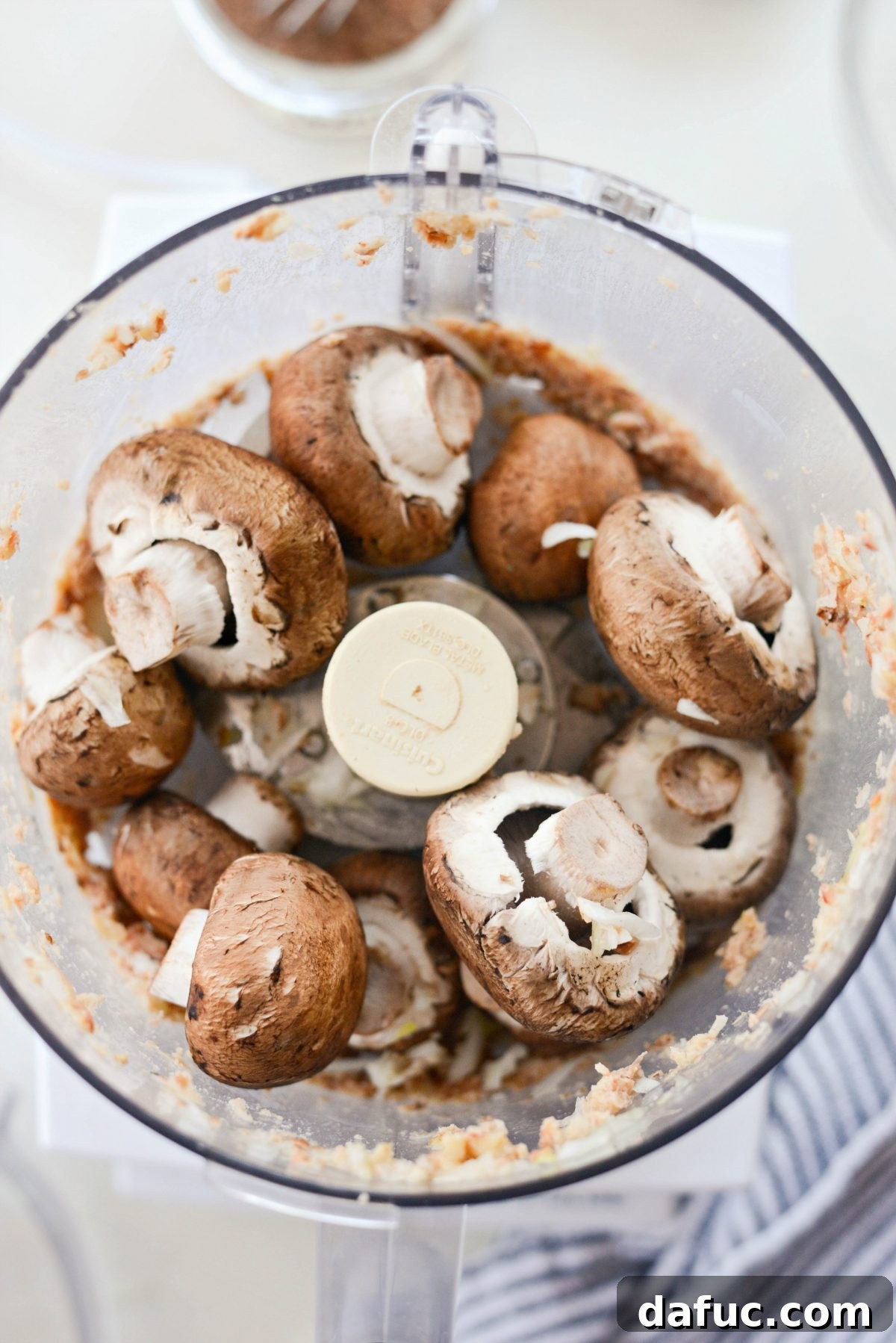 Removing fava bean and walnut mixture from food processor to add mushrooms