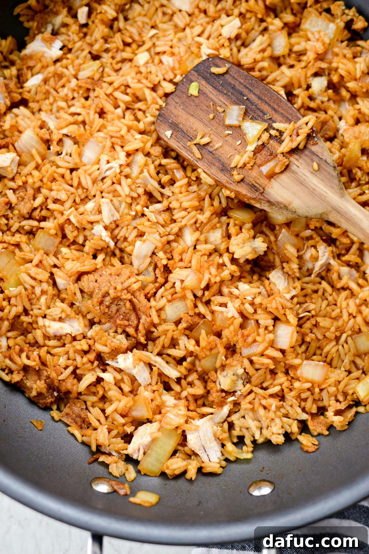 flatten and press the fried rice into the pan for crispiness