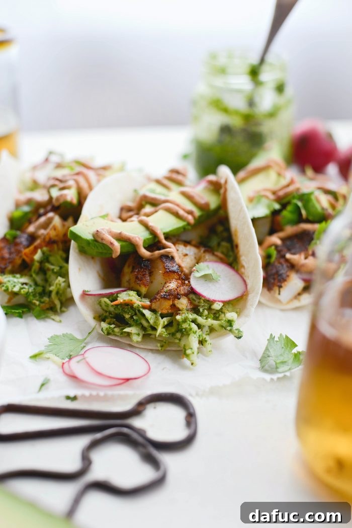 A completed Blackened Fish Taco with a beer in the background