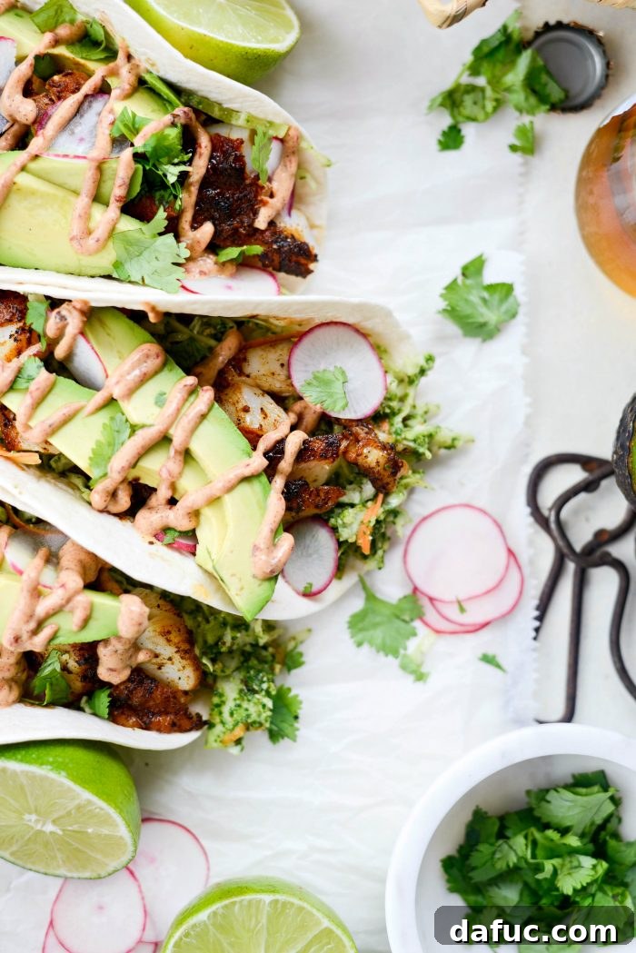 Stack of Blackened Fish Tacos with fresh lime and cilantro garnish
