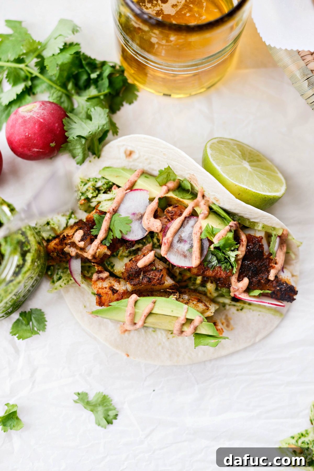 A top-down view of a spread of Blackened Fish Tacos, showing their vibrant and enticing colors.