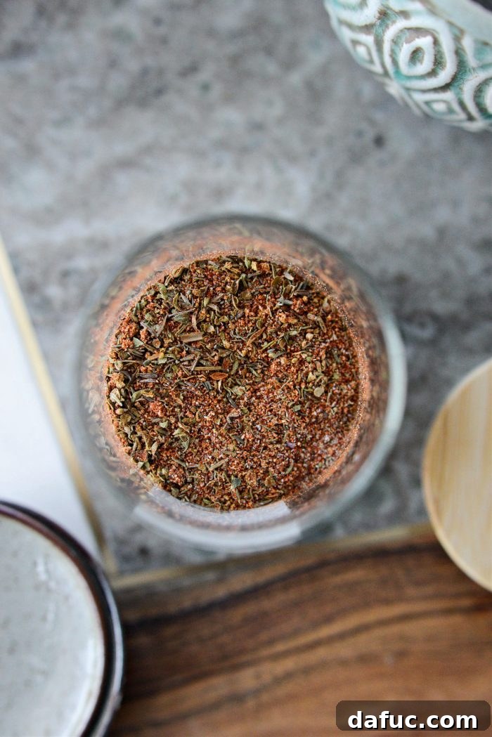 Craft Your Own Blackened Rub 3 Blackened Seasoning sprinkled over various foods like chicken, fish, and vegetables, ready for cooking.
