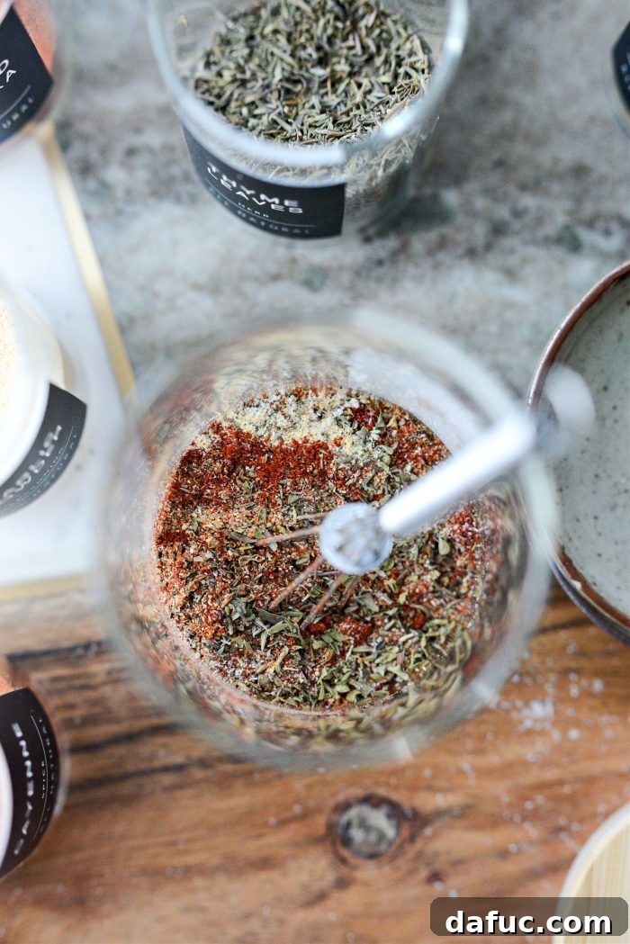 Craft Your Own Blackened Rub 6 A small whisk being used to combine the measured dry spices thoroughly in a glass jar.