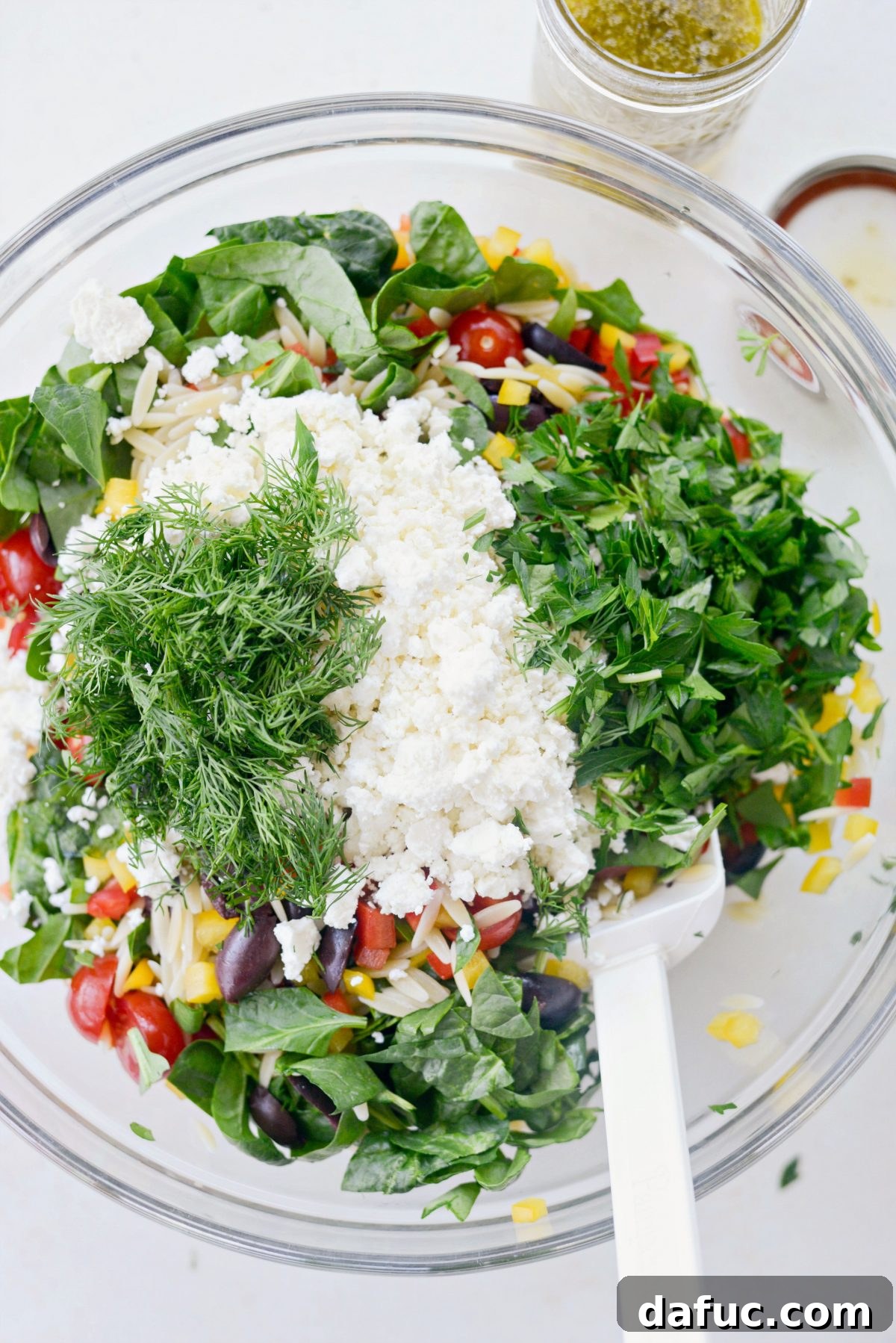 Vibrant Mediterranean Orzo Salad 8 All salad ingredients mixed together in a large glass mixing bowl