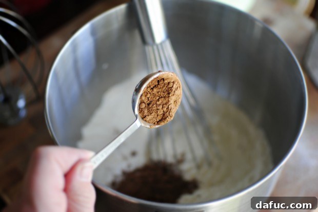 Timeless Red Velvet Cake 12 A bowl containing all-purpose flour, granulated sugar, unsweetened cocoa, kosher salt, and baking soda, the dry ingredients for Classic Red Velvet Cake.