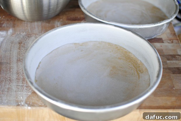 Timeless Red Velvet Cake 17 The two 9-inch cake pans, perfectly greased, floured, and lined with parchment paper, ready to receive the Red Velvet Cake batter.