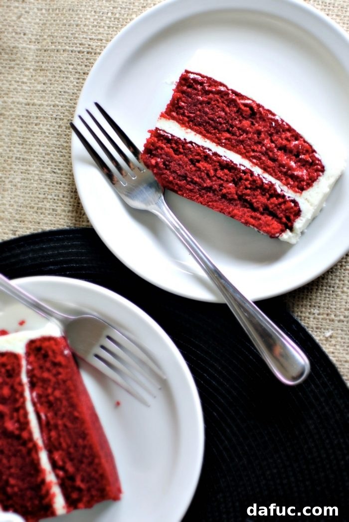 Timeless Red Velvet Cake 3 A beautiful two-tiered Classic Red Velvet Cake with a generous layer of cream cheese frosting, ready for a birthday celebration.