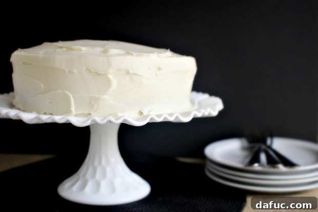 Timeless Red Velvet Cake 29 The fully frosted Classic Red Velvet Cake, showcasing a perfectly smooth layer of cream cheese frosting, ready to be served.